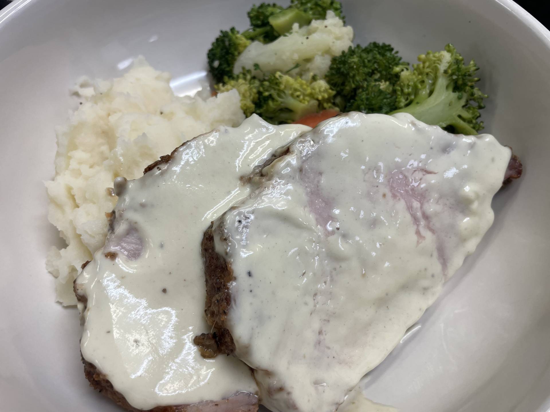 Herb Roasted Pork Loin with Dijon Cream Sauce on Mashed Potatoes with Steamed Veg Blend
